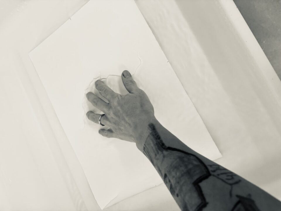Place paper in water and submerge.