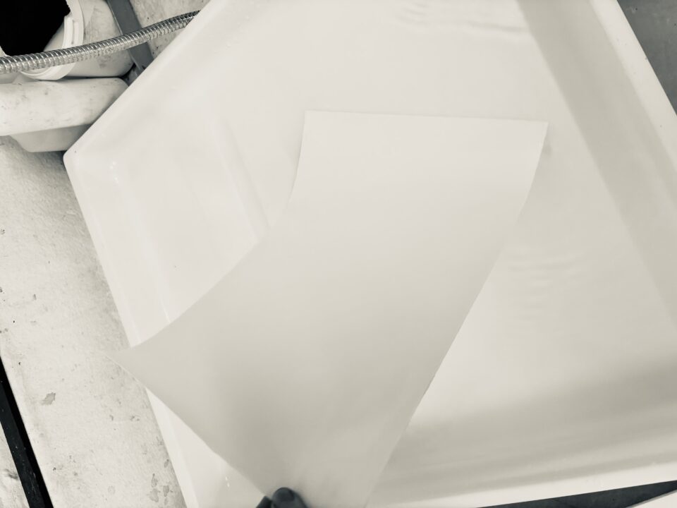 Turn paper around ensure other side cover with water.