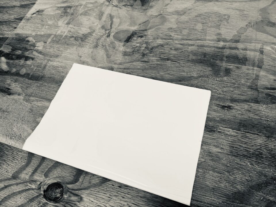 Fold vinyl over stack of paper.